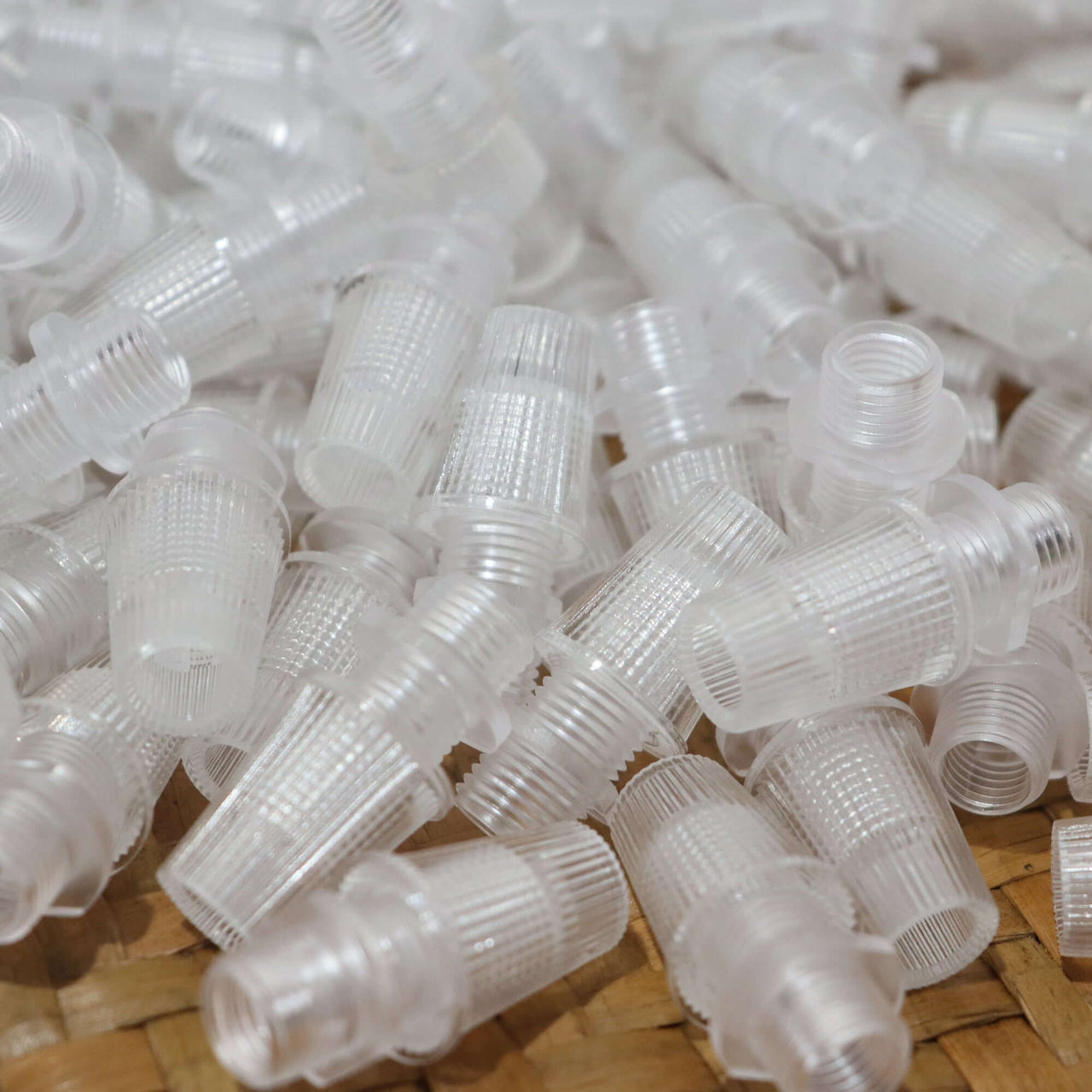 Cord Grips Lampshade Holder – Plastic Screw Style Cord Grip (20 pcs.) in a pile, made from durable clear plastic.