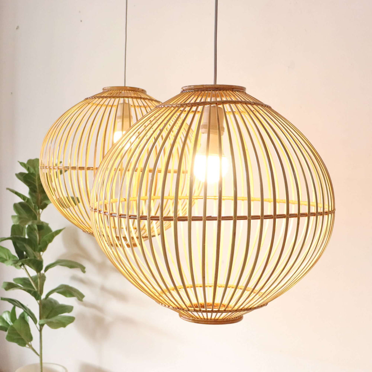 WARRADA — handwoven bamboo pendant light with an open weave that diffuses soft golden light
