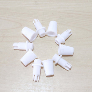 White Cord Grips Lampshade Holder – Plastic Screw Style Cord Grip (20 pcs.) arranged in a circle on a wooden surface.