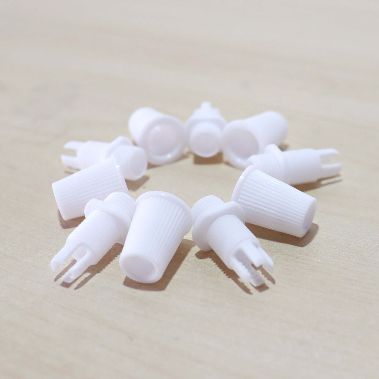 White Cord Grips Lampshade Holder – Plastic Screw Style Cord Grip (20 pcs.) arranged in a circular formation.