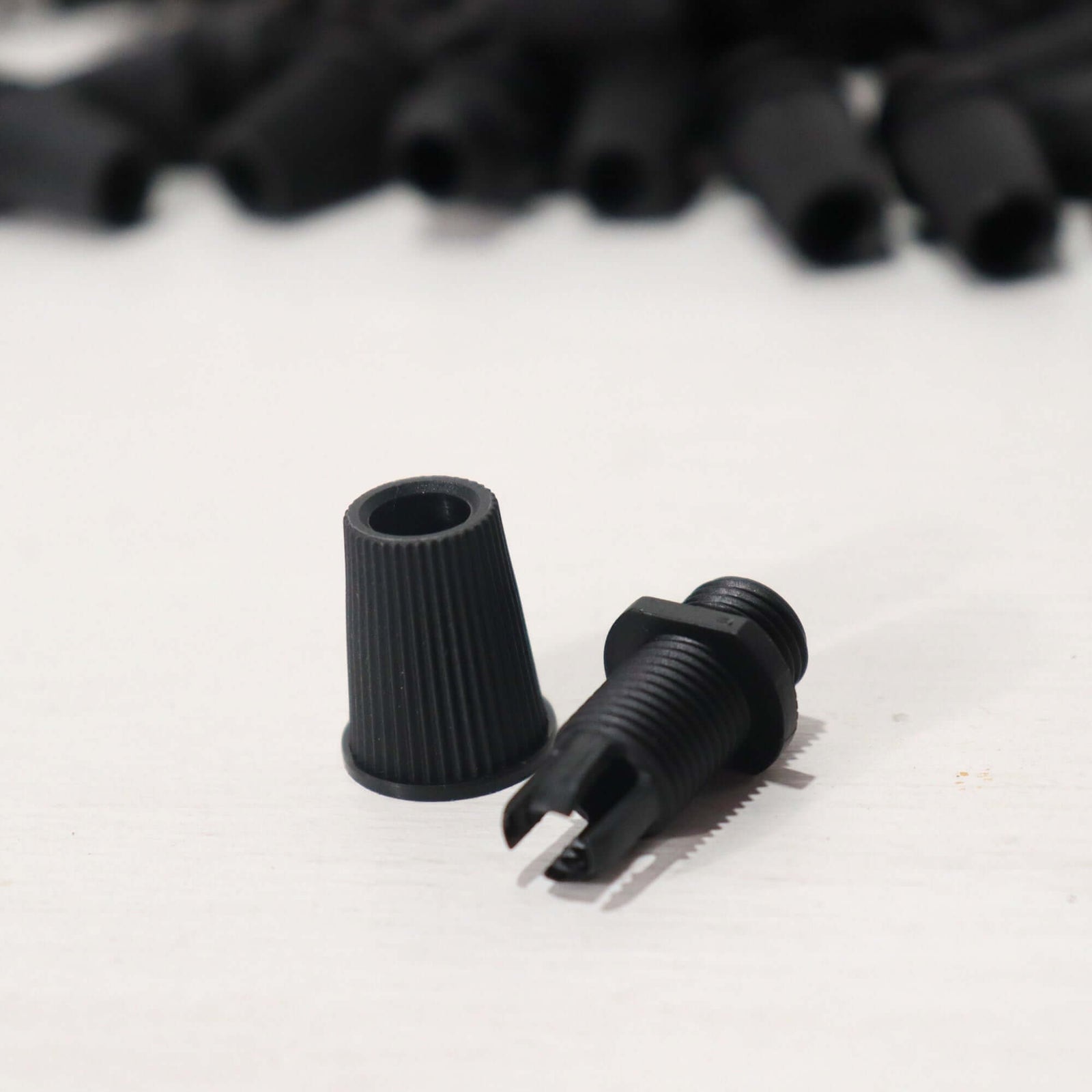 Black Cord Grips Lampshade Holder – Plastic Screw Style Cord Grip (20 pcs.) showing pieces on a light surface.