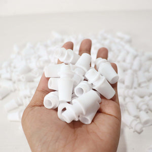 White Cord Grips Lampshade Holder – Plastic Screw Style Cord Grip (20 pcs.) held in hand with many around.