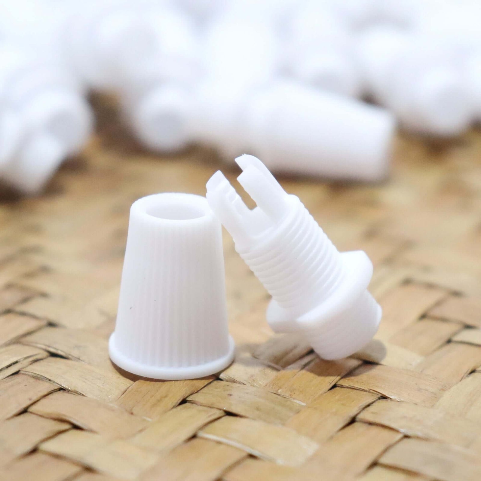 White Cord Grips Lampshade Holder – Plastic Screw Style Cord Grip (20 pcs.) arranged on woven surface.