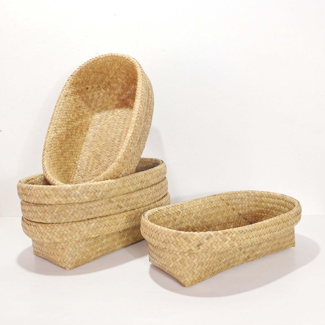 Nattalee Oval Pandanus Basket Natural stacked and arranged for elegant storage solutions in home decor.