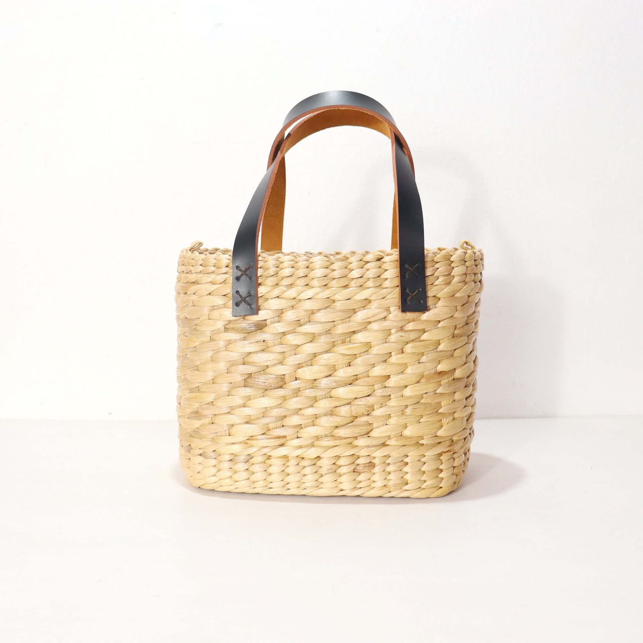 Handwoven straw handbag with natural woven texture, by Thai artisans