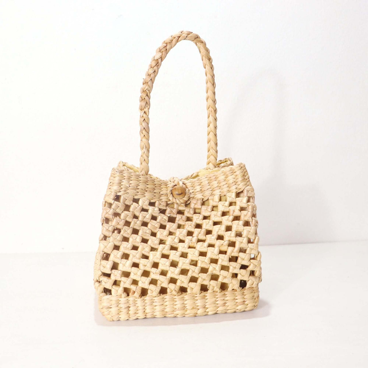 Handwoven straw handbag with natural woven texture, by Thai artisans