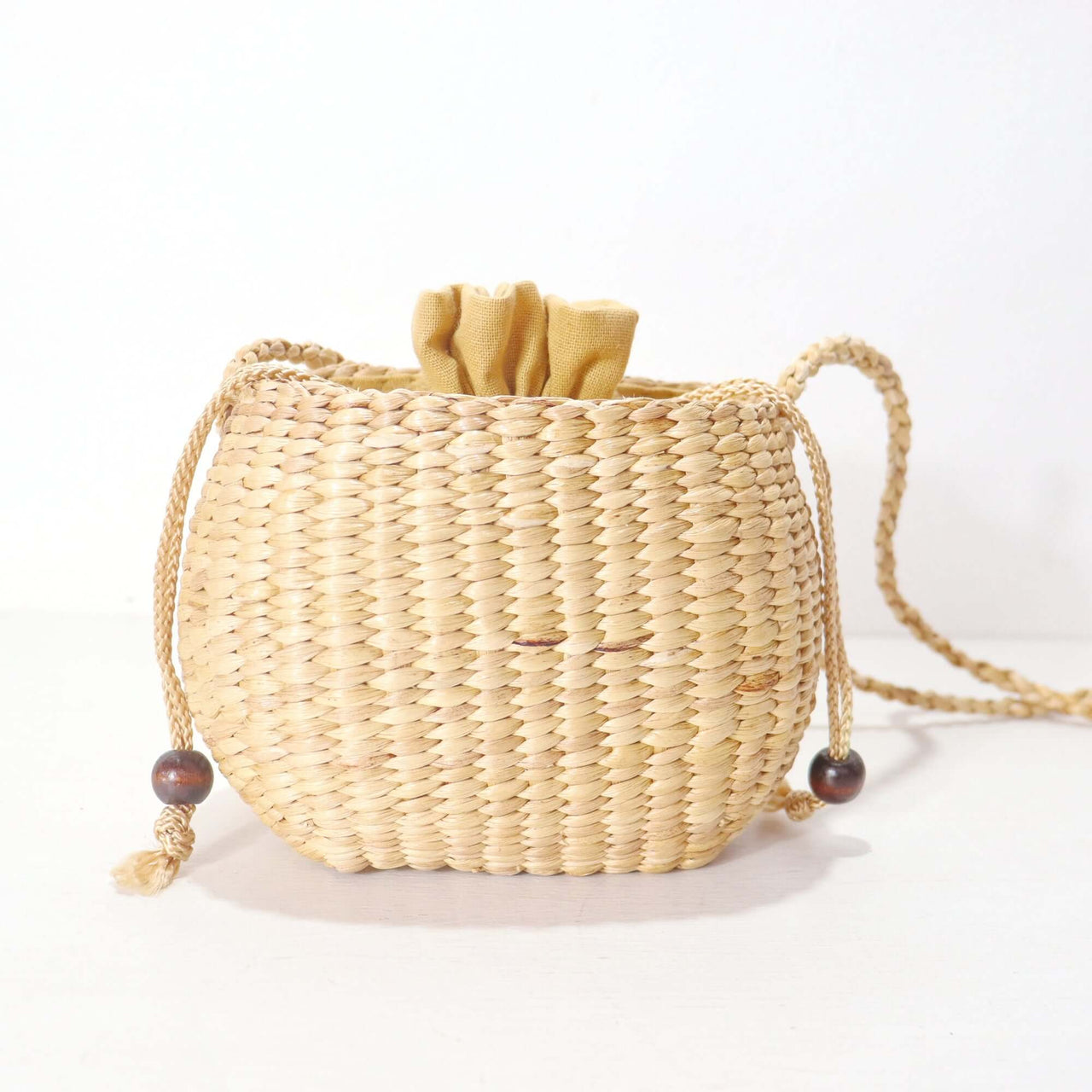 WANAREE - Cross Body Bag made of woven material with a drawstring closure for stylish everyday use.