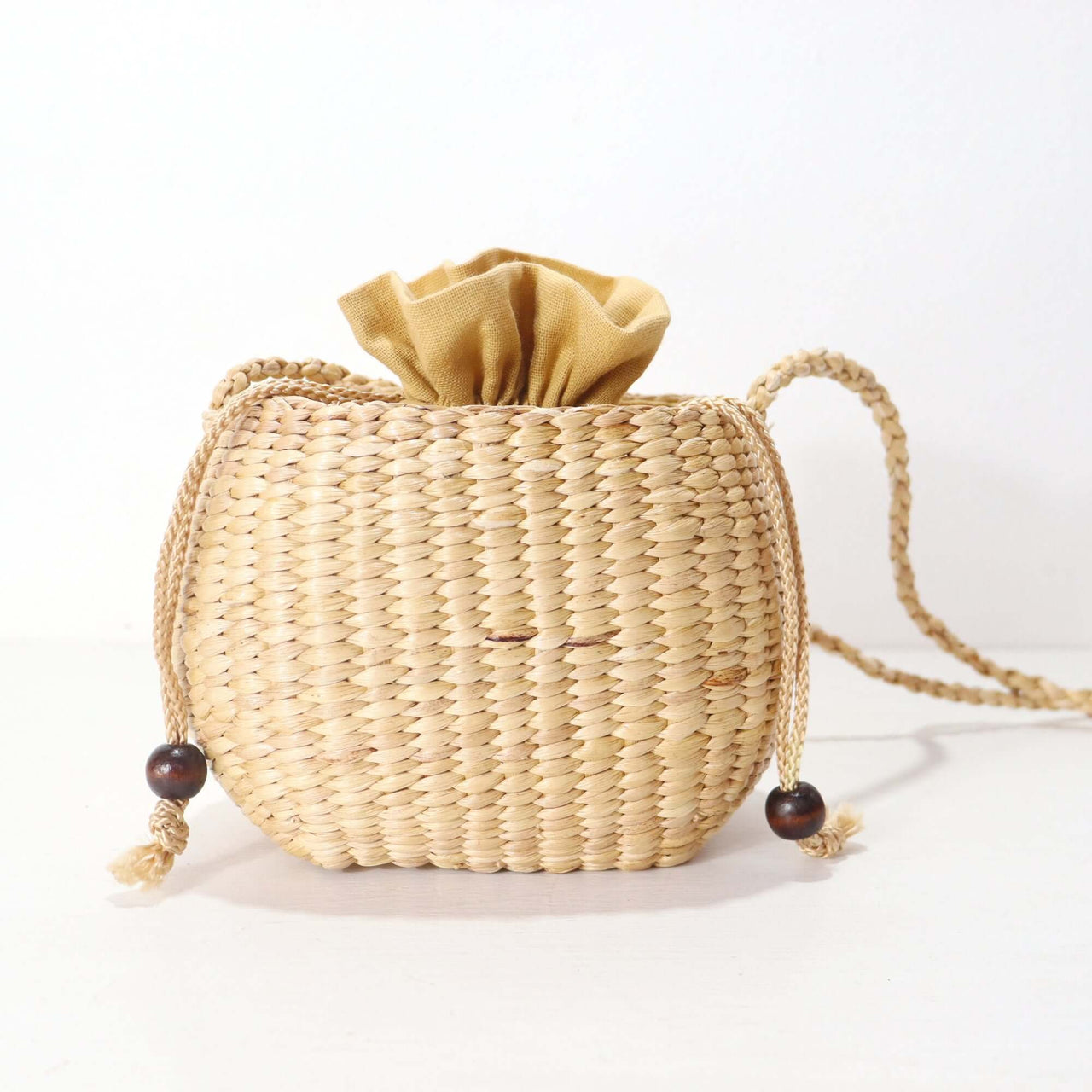 WANAREE - Cross Body Bag, a stylish and compact woven bag with a drawstring closure, perfect for everyday use.