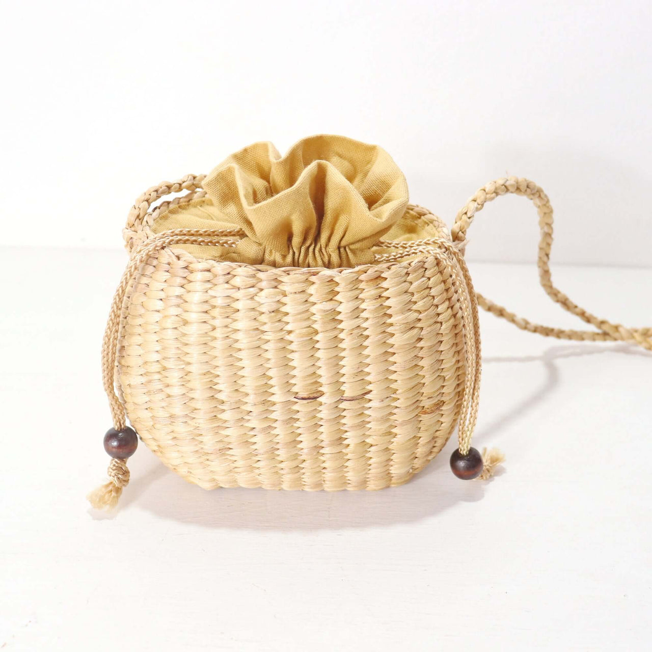 WANAREE - Cross Body Bag in woven design, featuring a golden pouch and adjustable strap, perfect for everyday use.