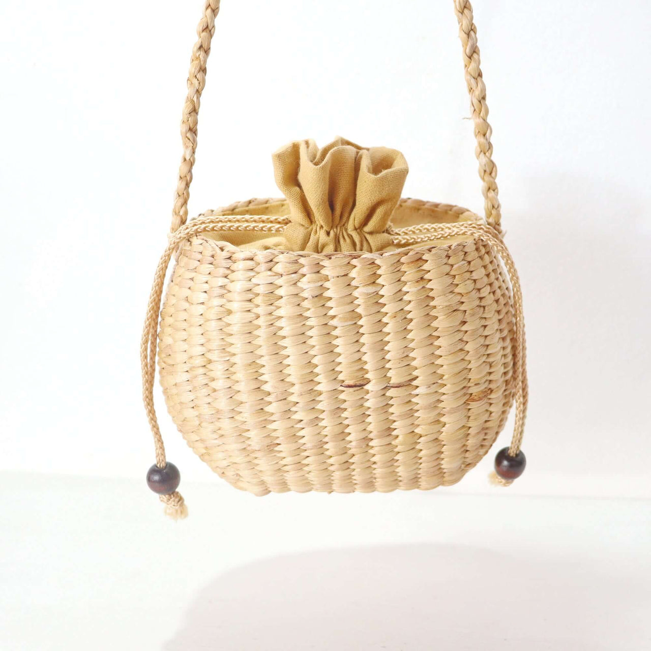 WANAREE - Cross Body Bag with a braided strap and drawstring closure, ideal for everyday use.