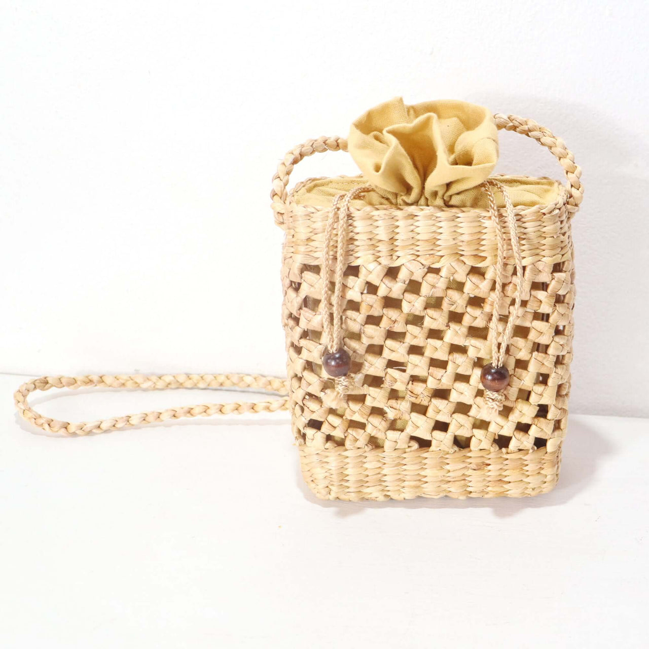 Talanee — handwoven straw crossbody bag with a soft, natural weave