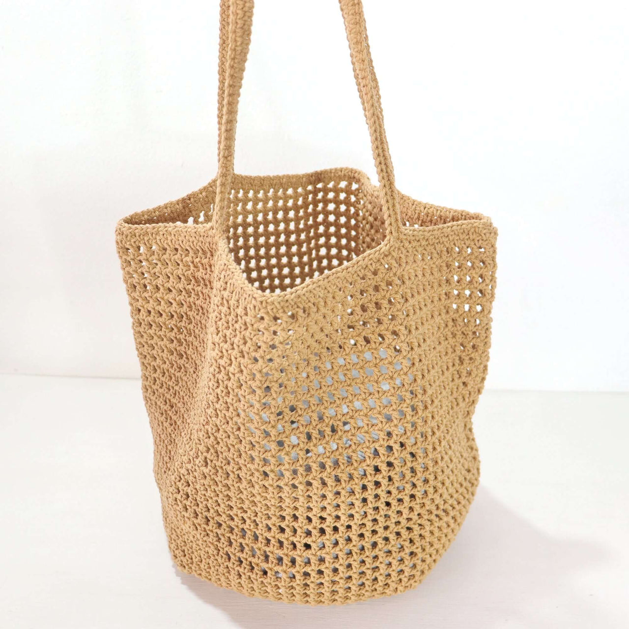 Brown - Crochet Shoulder Bag made from soft textured natural materials, showcasing a beautifully woven design.