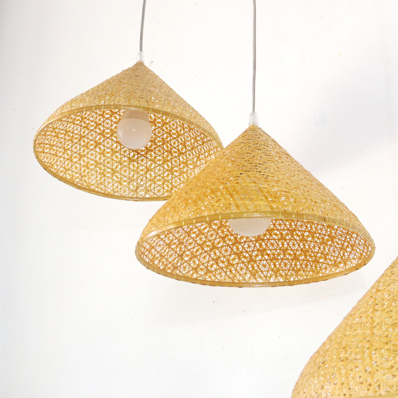 YEN — handwoven bamboo pendant light with an open weave that diffuses soft golden light