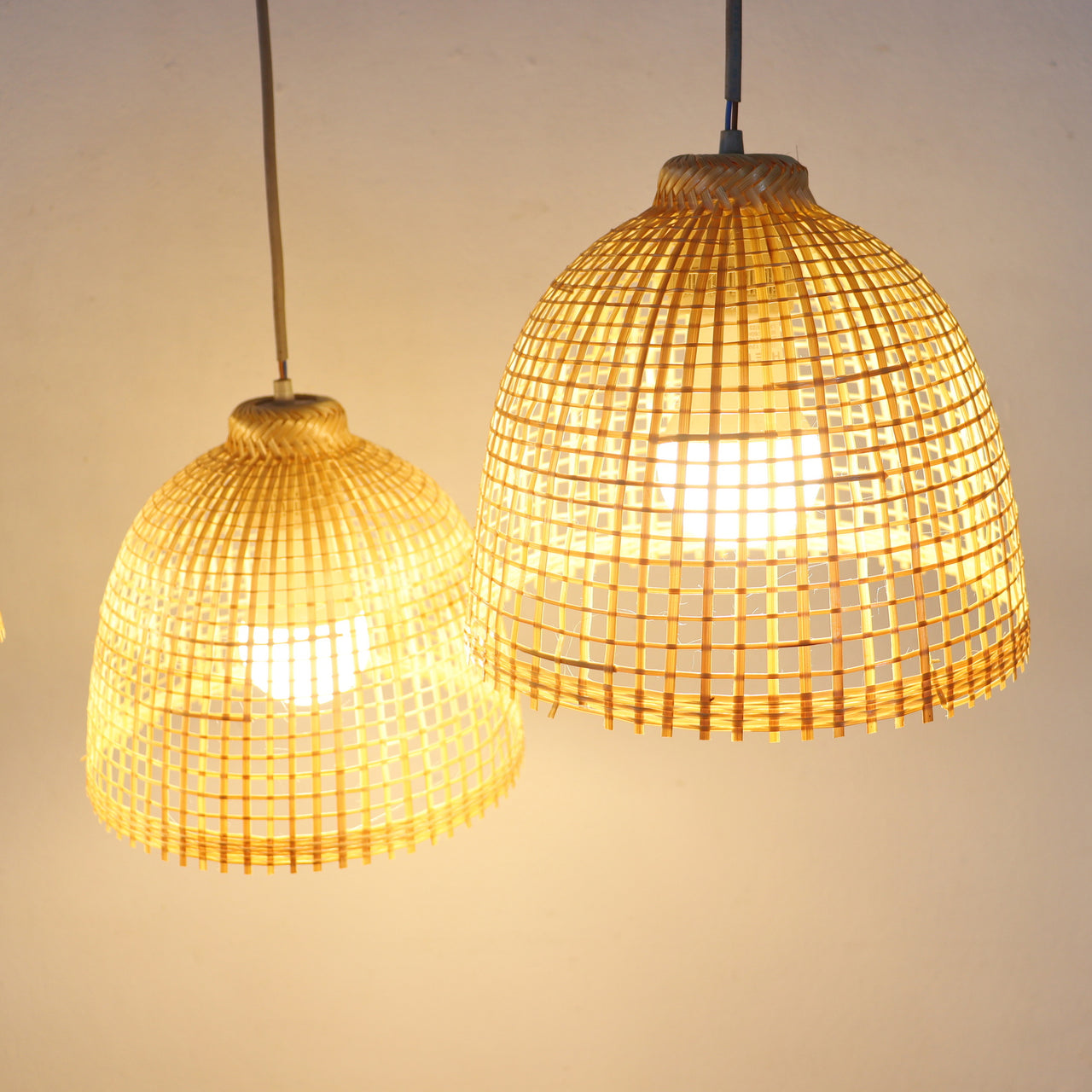 SAMA — handwoven bamboo pendant light shade with an open weave that diffuses soft golden light