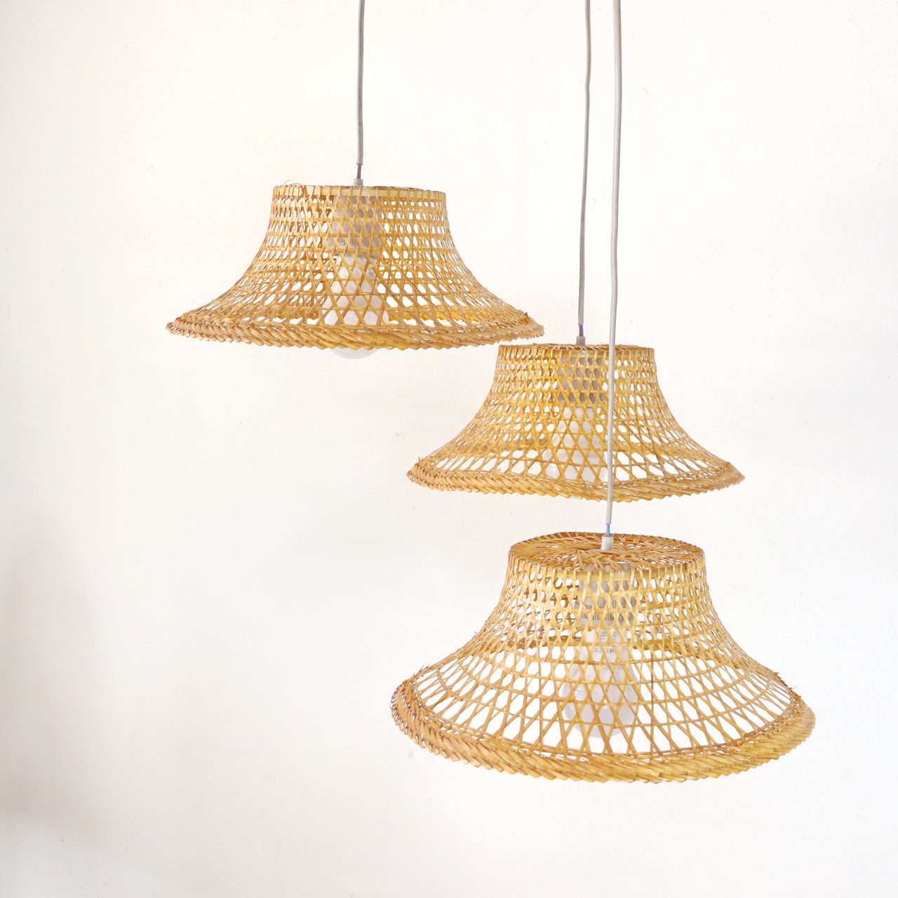 ANANDA — handwoven bamboo pendant light with an open weave that diffuses soft golden light