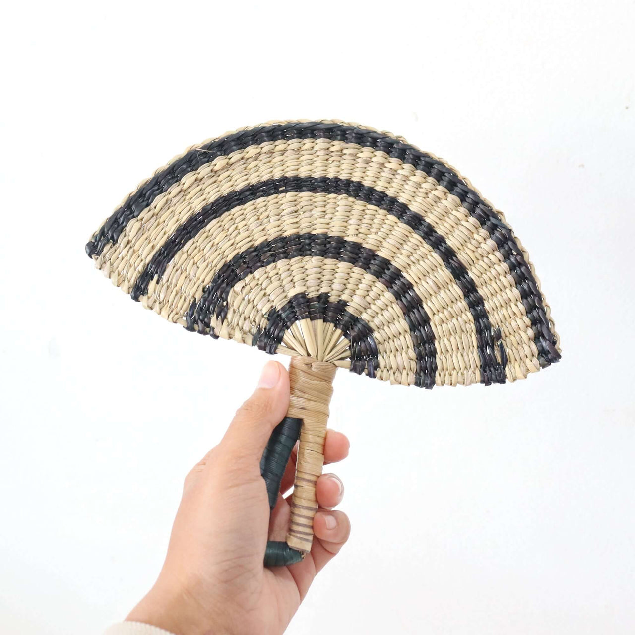 LA LIN – Handwoven Fan (Wall Hanging & Hand Fan) | Black & White in hand, showcasing its striking design.