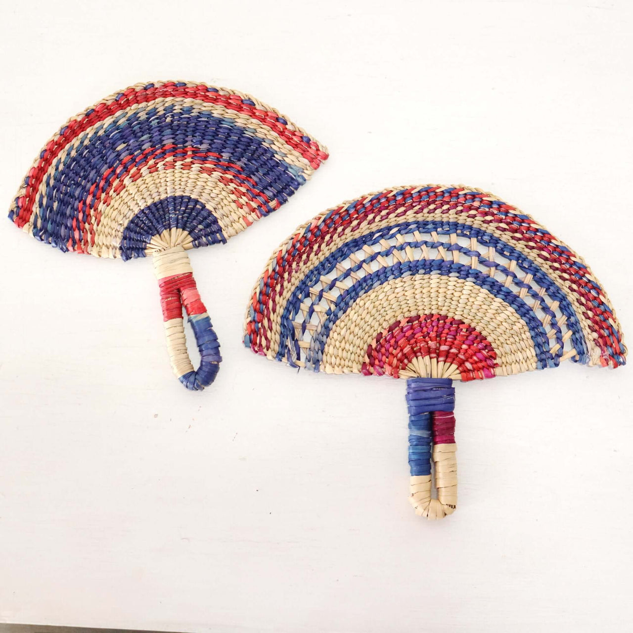 LA LA VAN – Handwoven Fan (Wall Hanging & Hand Fan) featuring colorful multicolored patterns and wicker handles.
