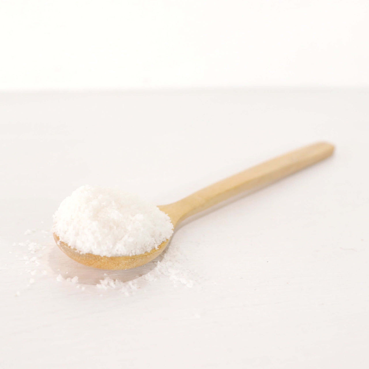 SU THI MA Wooden Honey Spoon holding granulated sugar on a white background, ideal for adding sweetness to dishes.