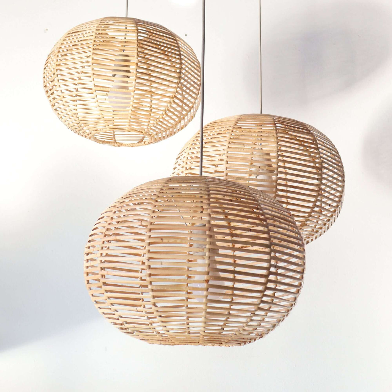 KAN — rattan pendant light above a dining table for warm ambient glow