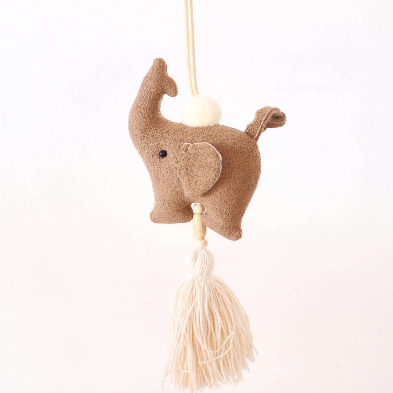 KADARA handwoven tassel bag charm with natural woven texture, by Thai artisans