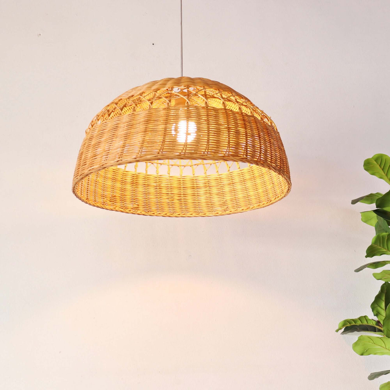 PARADEE — rattan pendant light above a dining table for warm ambient glow