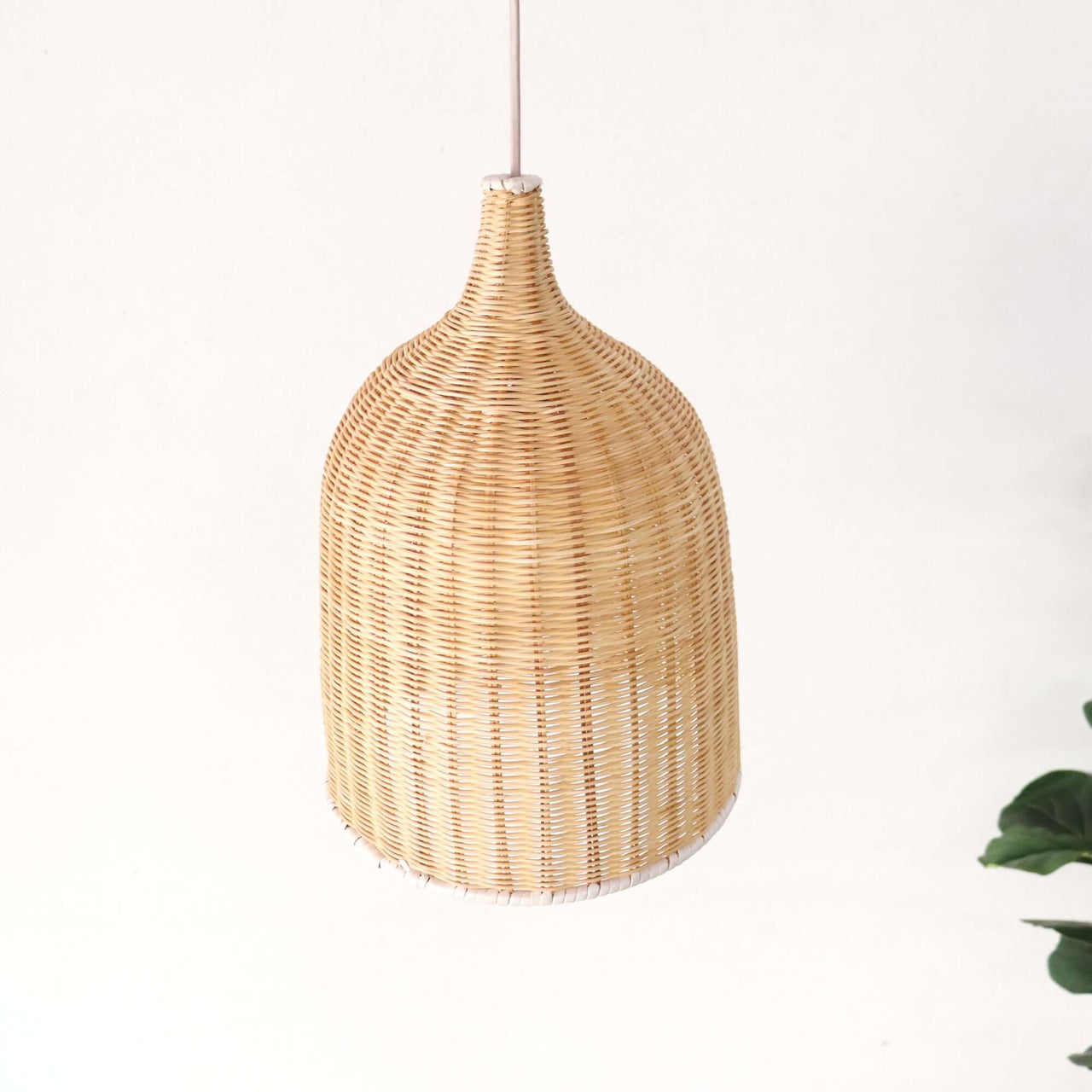 VILIA — rattan pendant light above a dining table for warm ambient glow