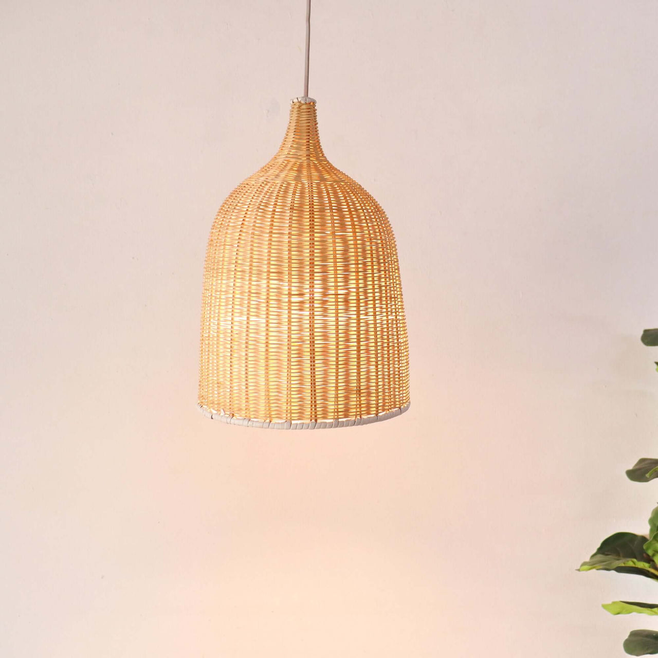 VILIA — handwoven rattan pendant light with an open weave that diffuses soft golden light