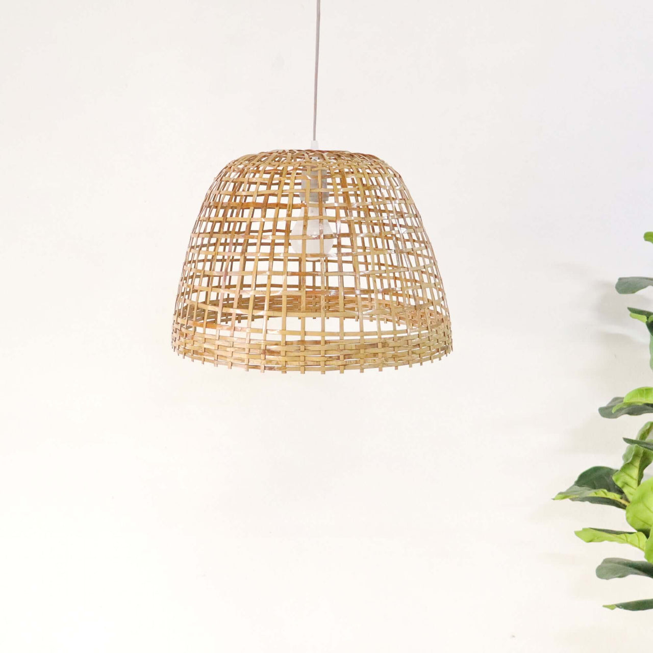 PIAREE — handwoven bamboo pendant light with an open weave that diffuses soft golden light