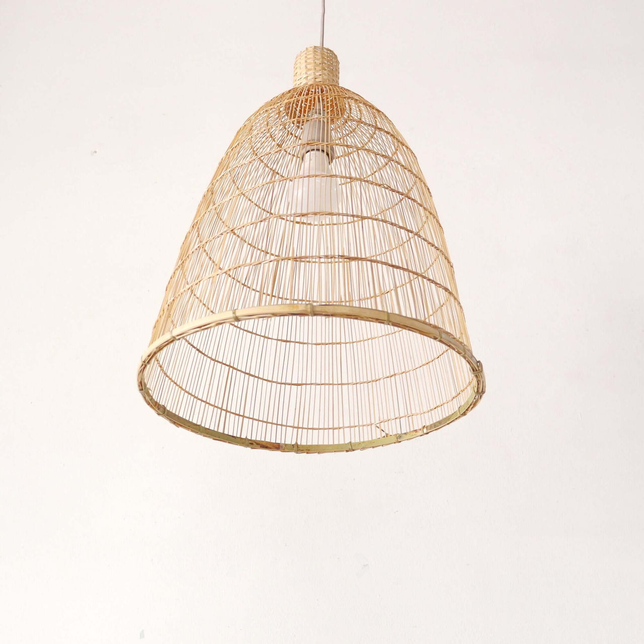 Bamboo pendant light shade above a dining table for warm ambient glow