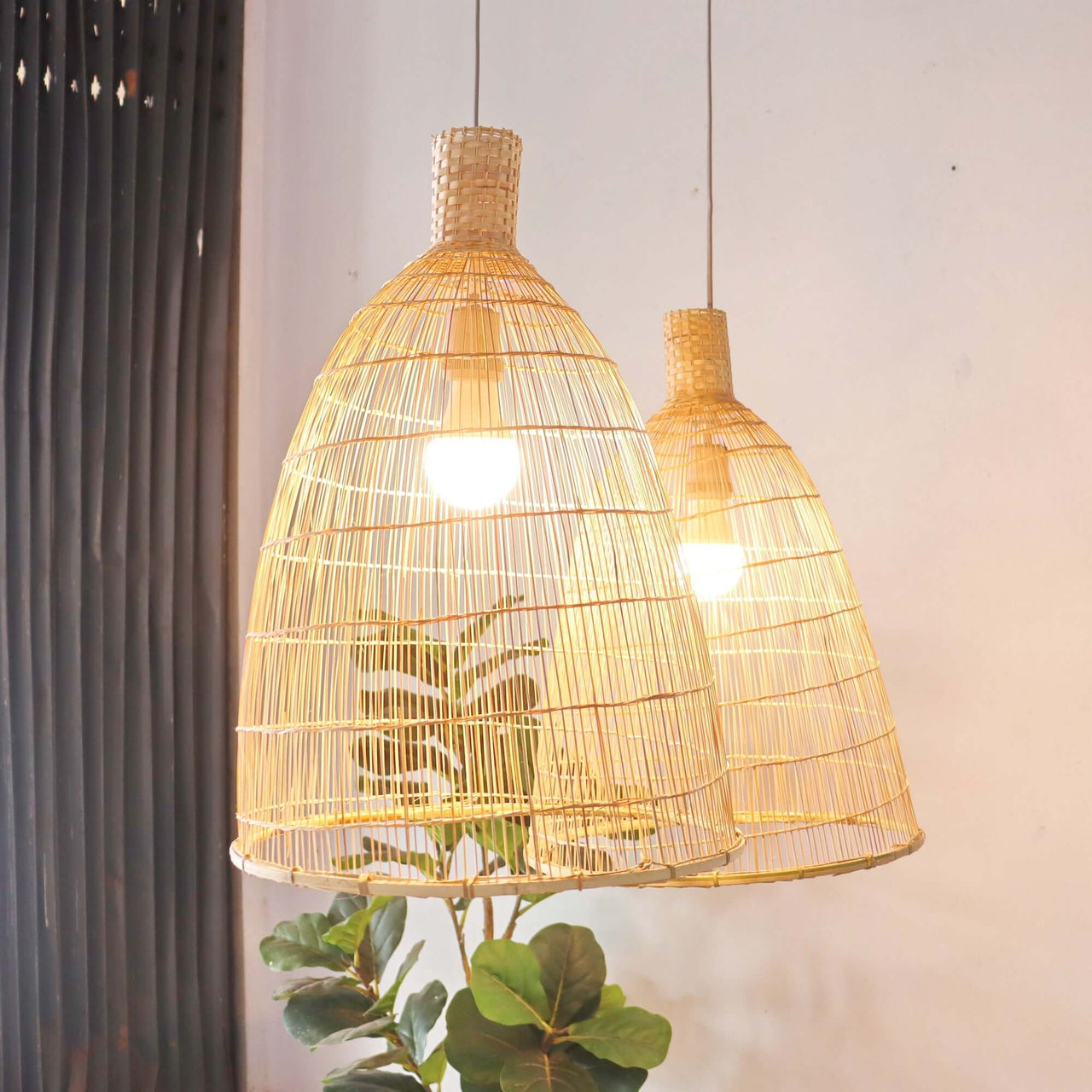 Handwoven bamboo pendant light shade with an open weave that diffuses soft golden light