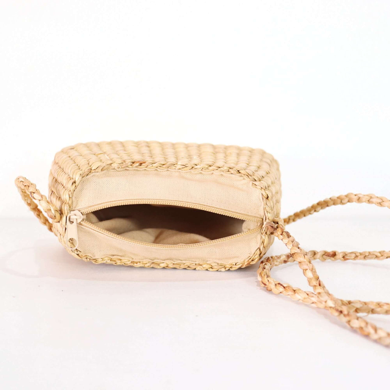 SARI PA PON - Cross Body Bag showing inside compartment and braided strap detail.