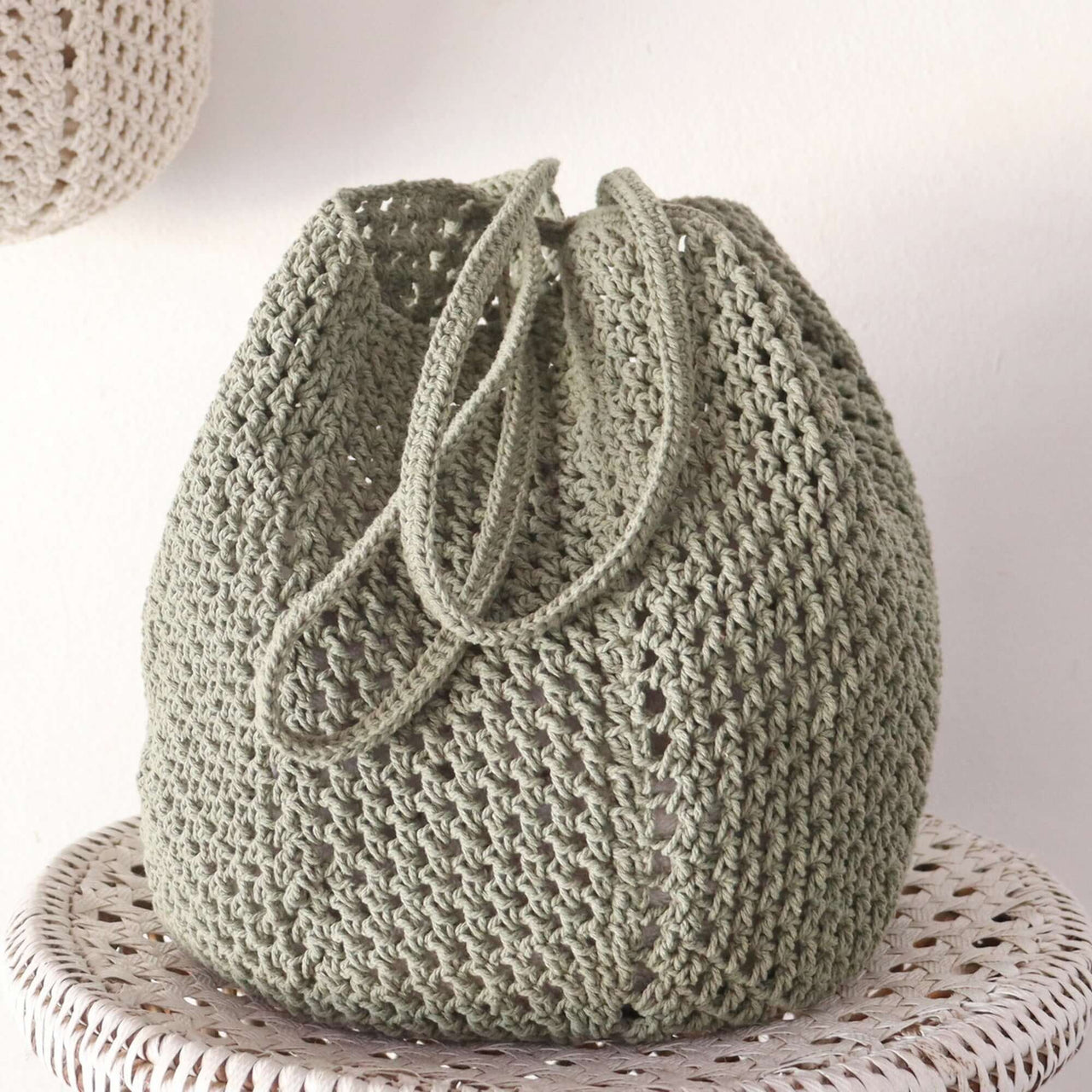 Olive — straw shoulder bag styled for summer beach outings