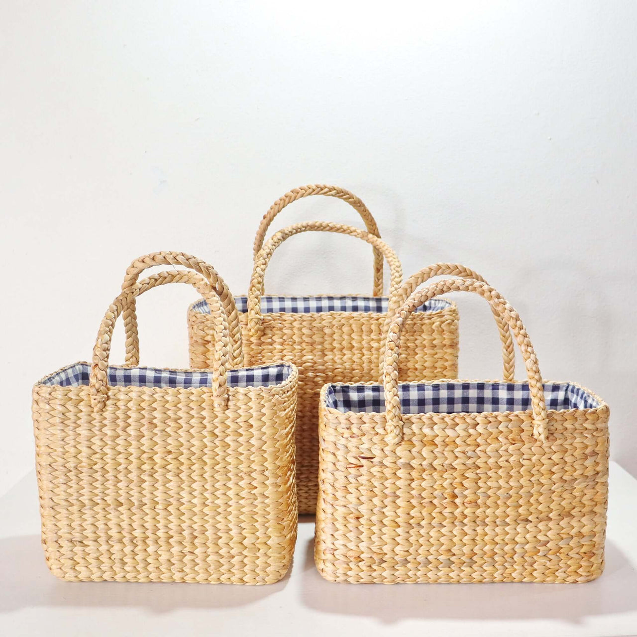 Handwoven straw basket bag with natural woven texture, by Thai artisans