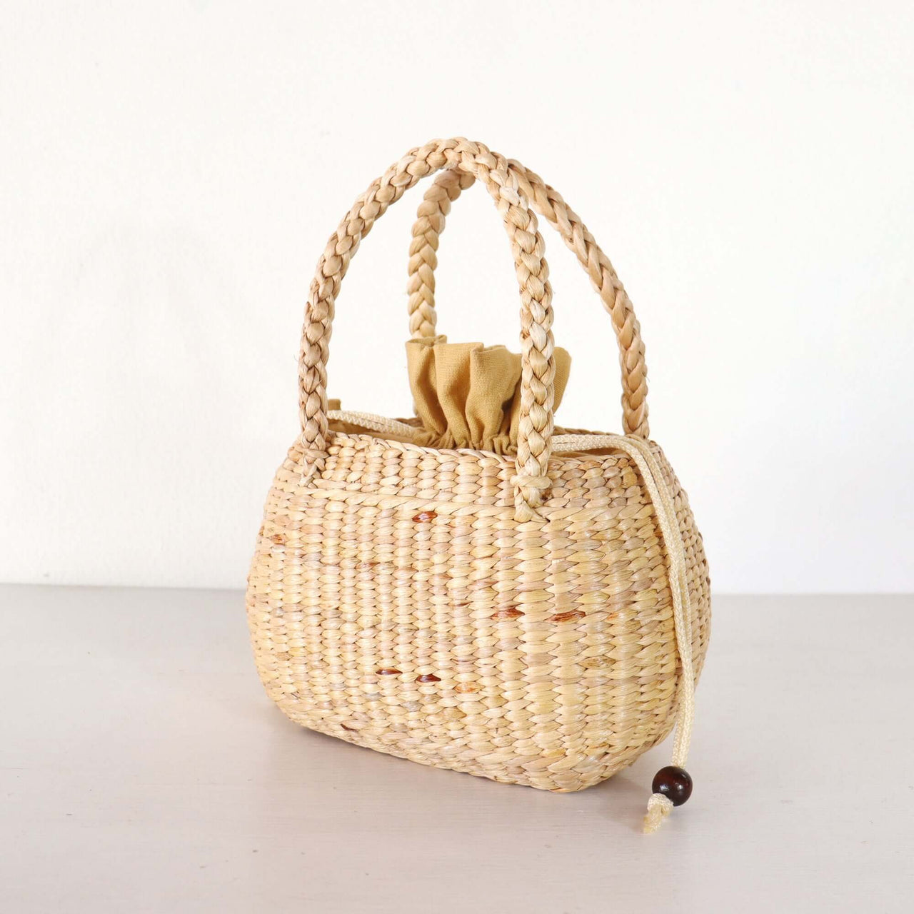 Nongpanee — handwoven straw basket bag with a soft, natural weave