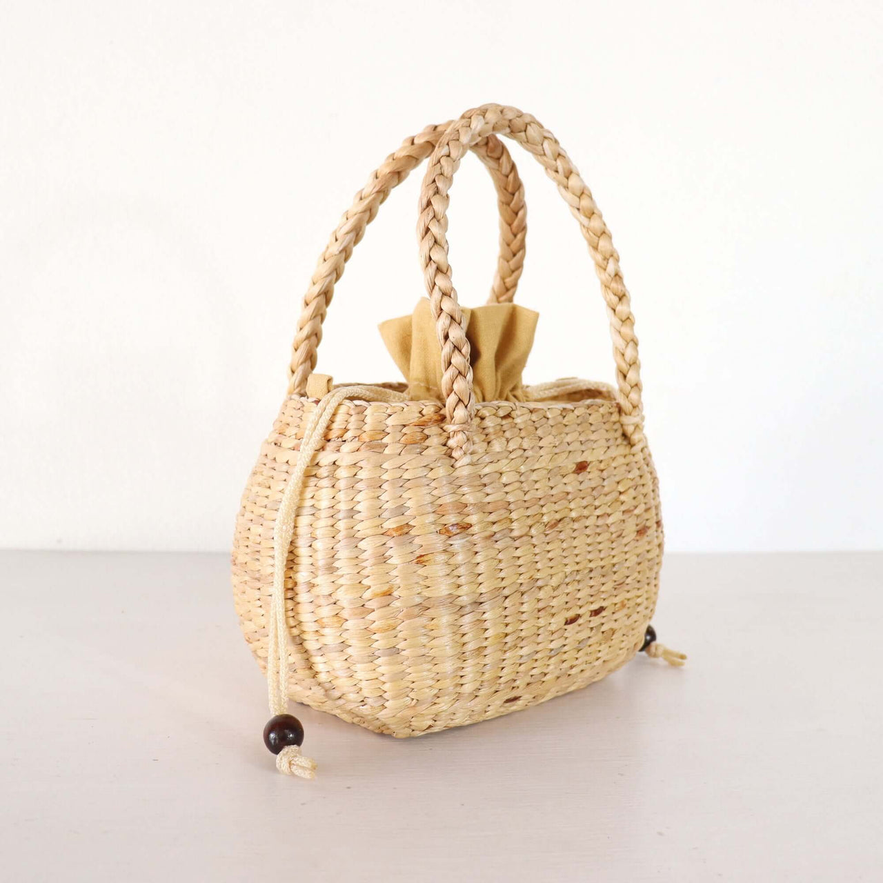 Nongpanee — straw basket bag styled for summer beach outings