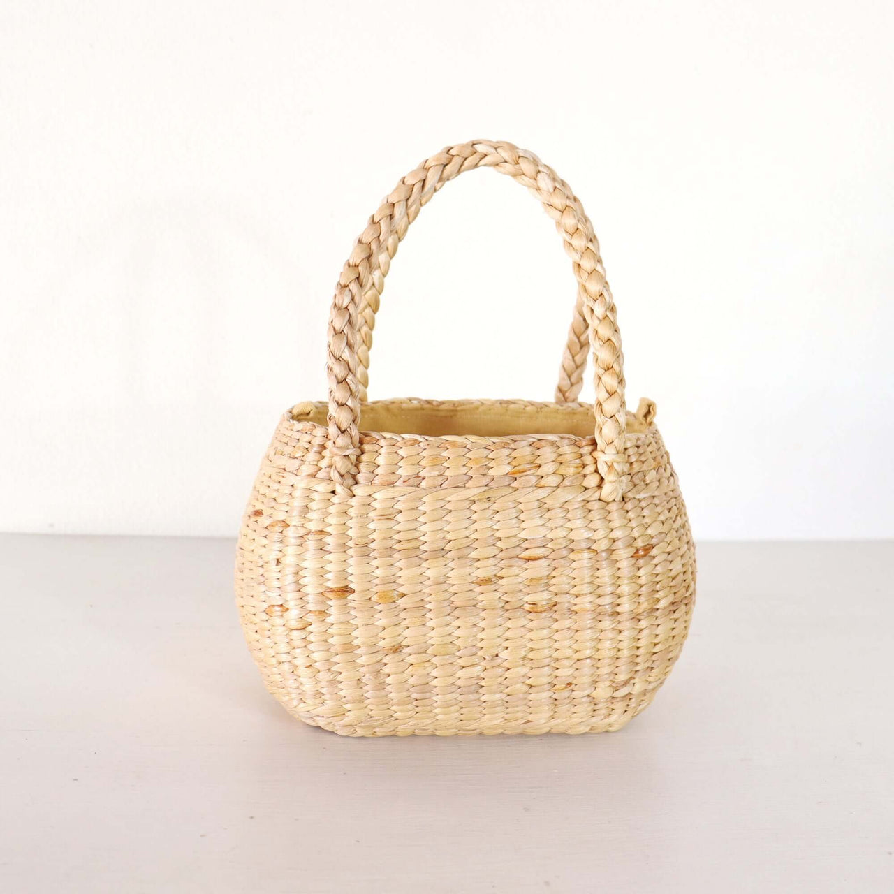 Nongpanee — straw basket bag with a relaxed, vacation-ready look