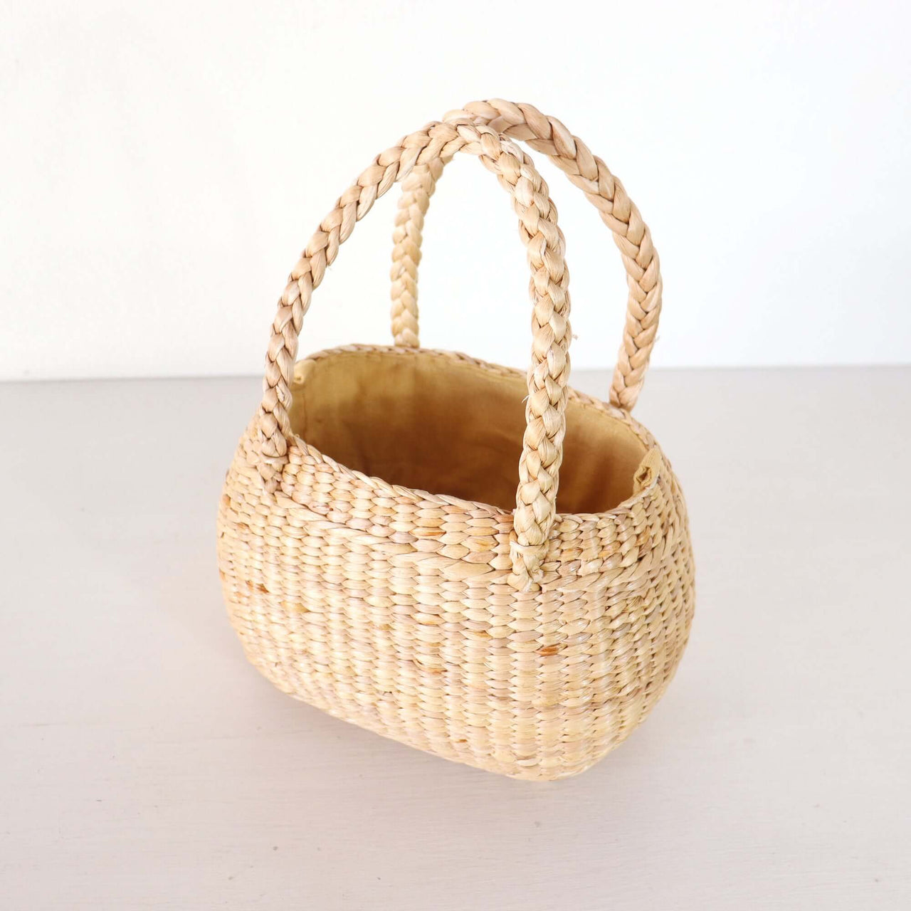 Nongpanee — lightweight straw basket bag for warm-weather styling