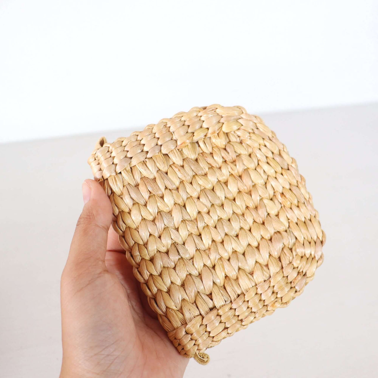 Handwoven straw wallet with natural woven texture, by Thai artisans