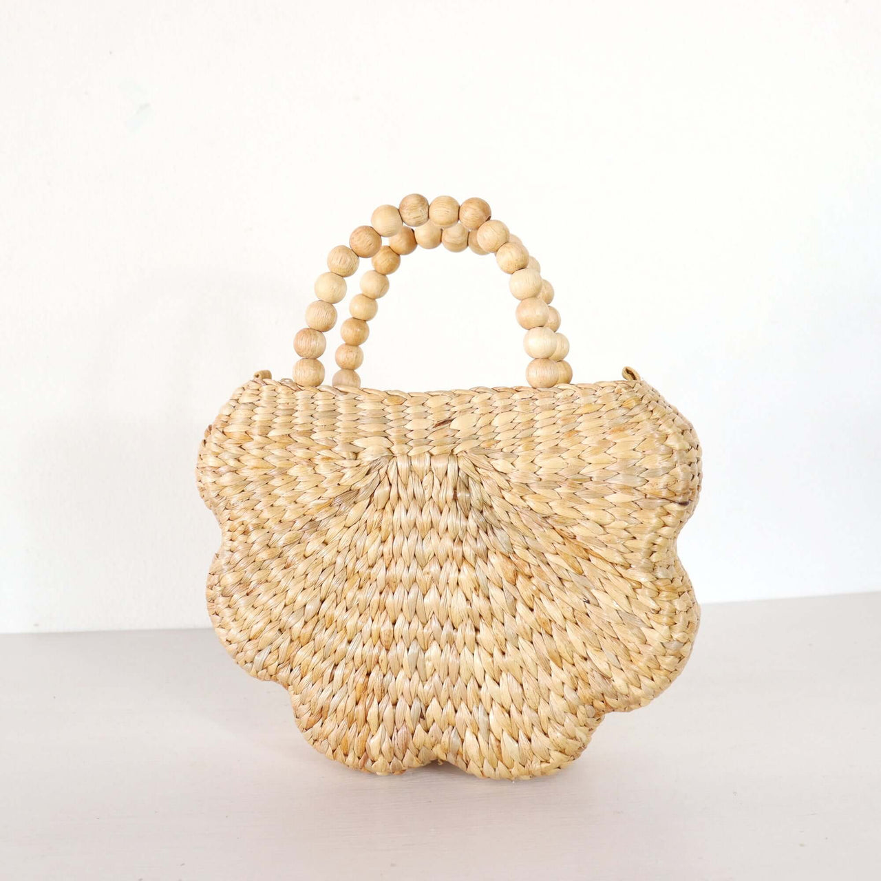 Handwoven straw handbag with natural woven texture, by Thai artisans