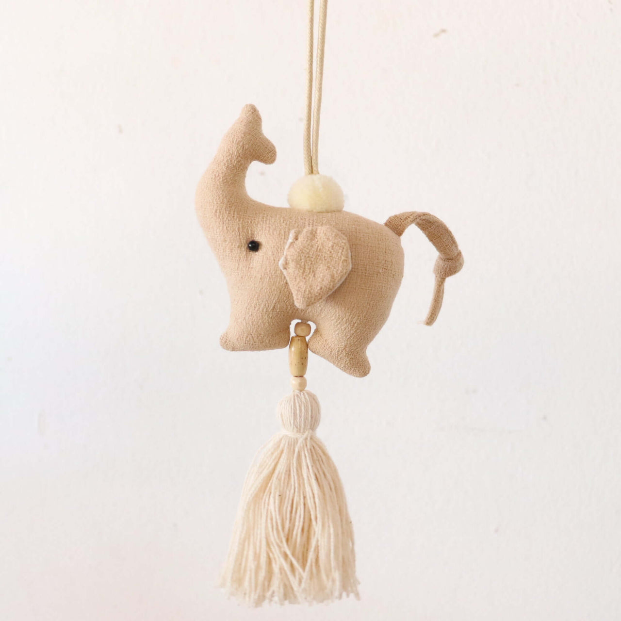 KADARA handwoven tassel bag charm with natural woven texture, by Thai artisans