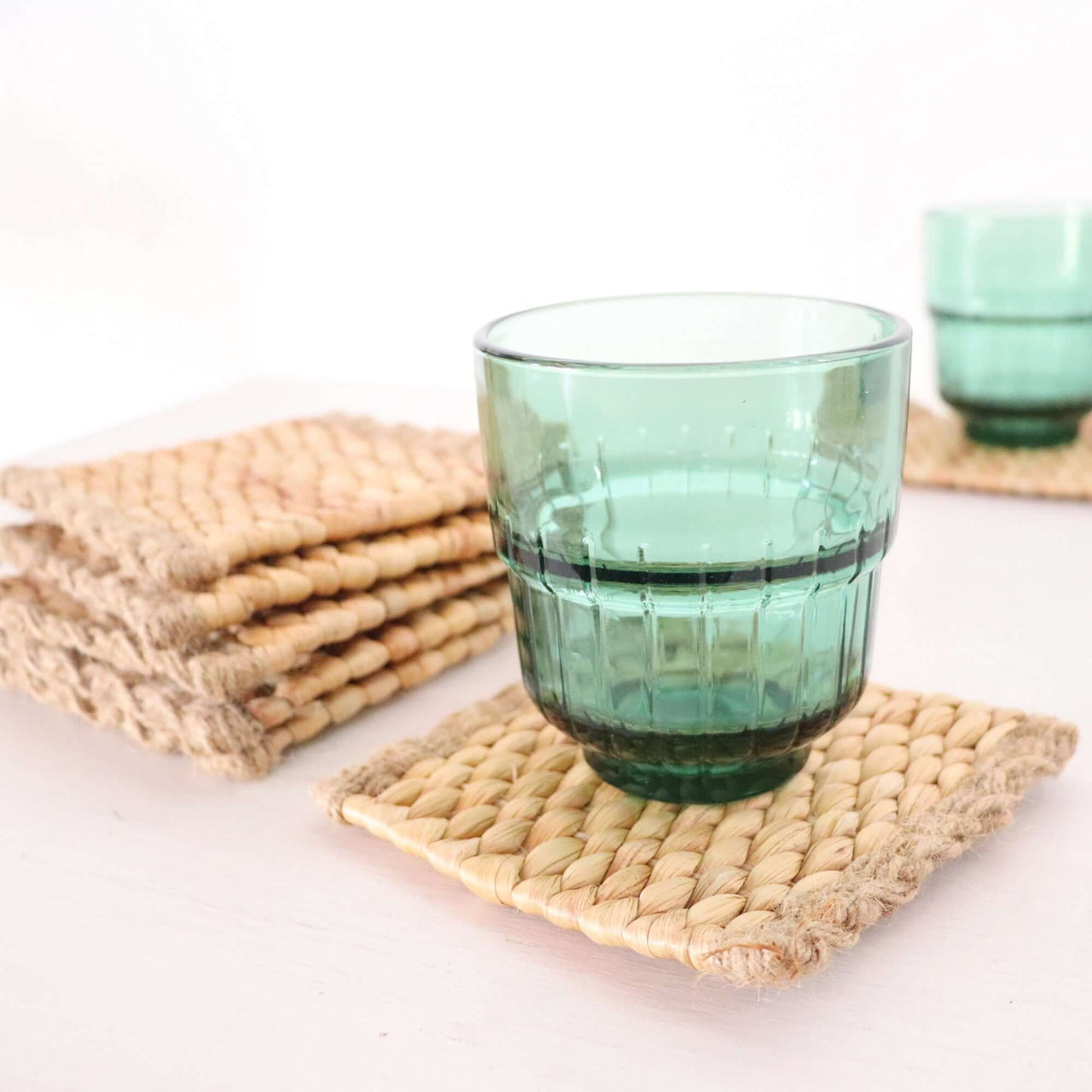 KA NOK PUN Water Hyacinth Boho Coaster Set of 4 with green glass on rustic coasters.