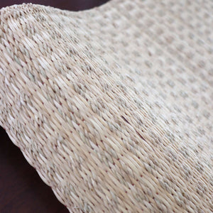 Close-up of a textured woven surface with a neutral color palette.