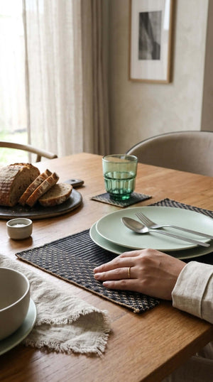 Stylish dining setup featuring the Lavila Handwoven Placemat with minimalist tableware and rustic bread.