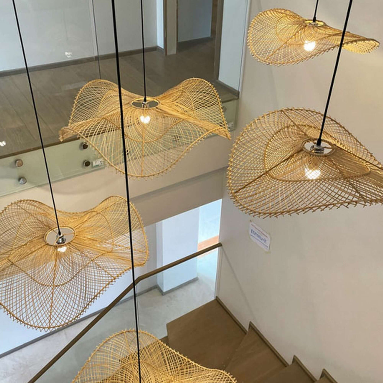 IYARA — handwoven rattan pendant light shade with an open weave that diffuses soft golden light