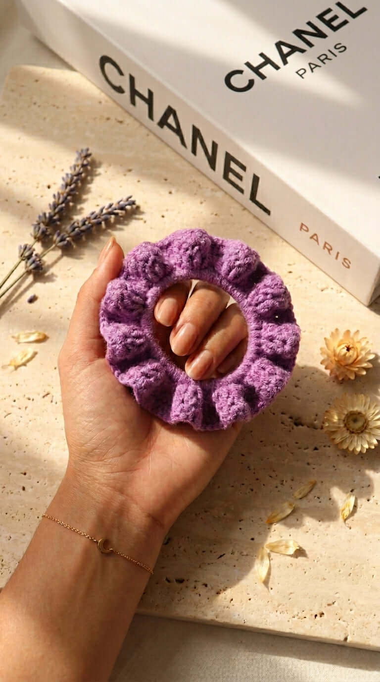Purple Tones - Hand Crochet Scrunchies in hand, featuring soft purple hues and textured design for elegant styling.